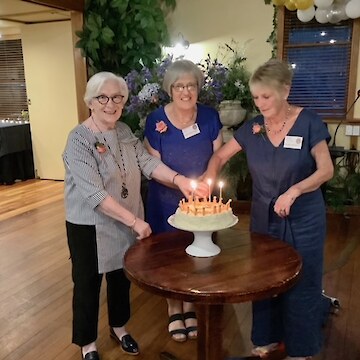 Our three life members ‘cutting the cake’.